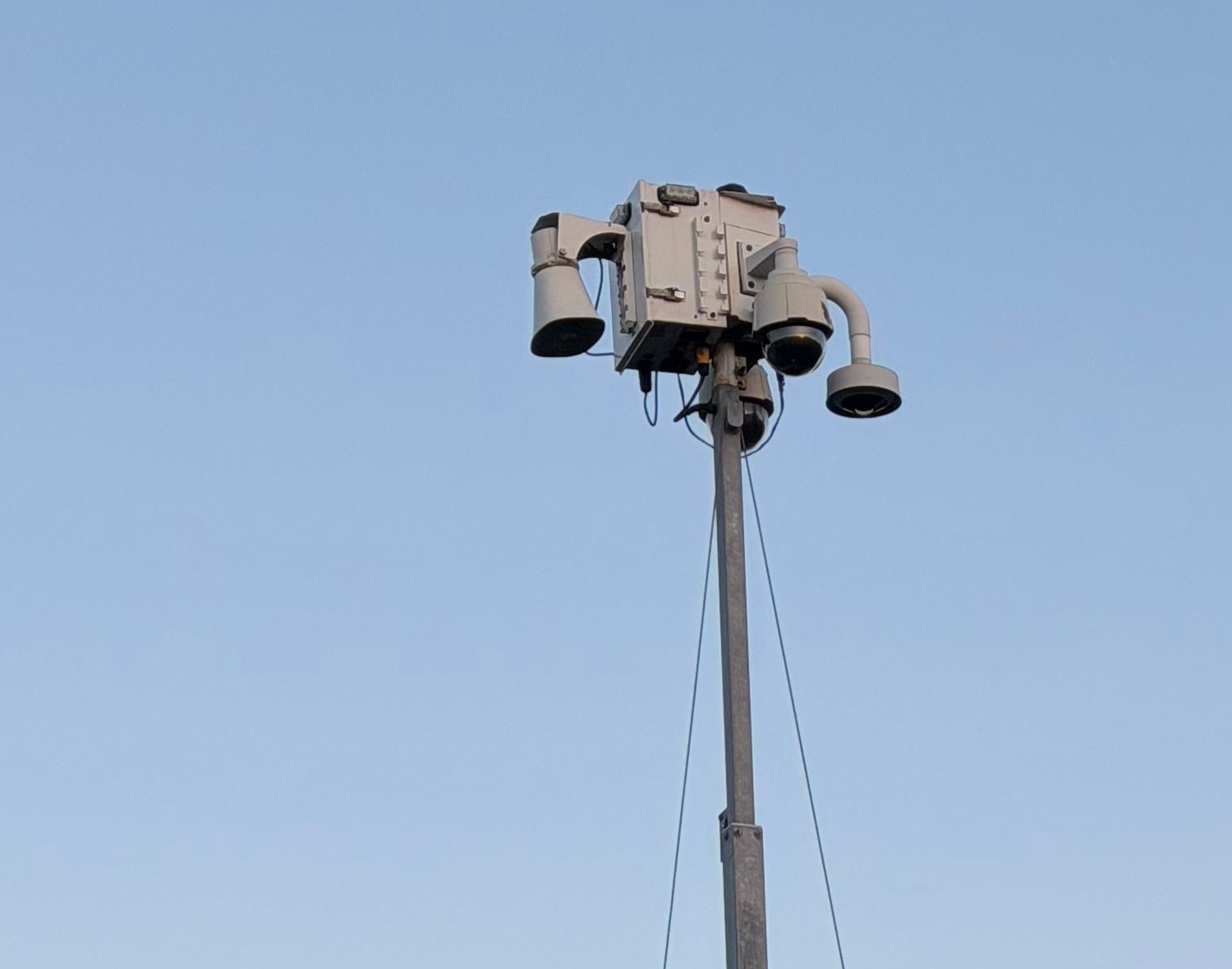 PTZ security camera mast at dusk